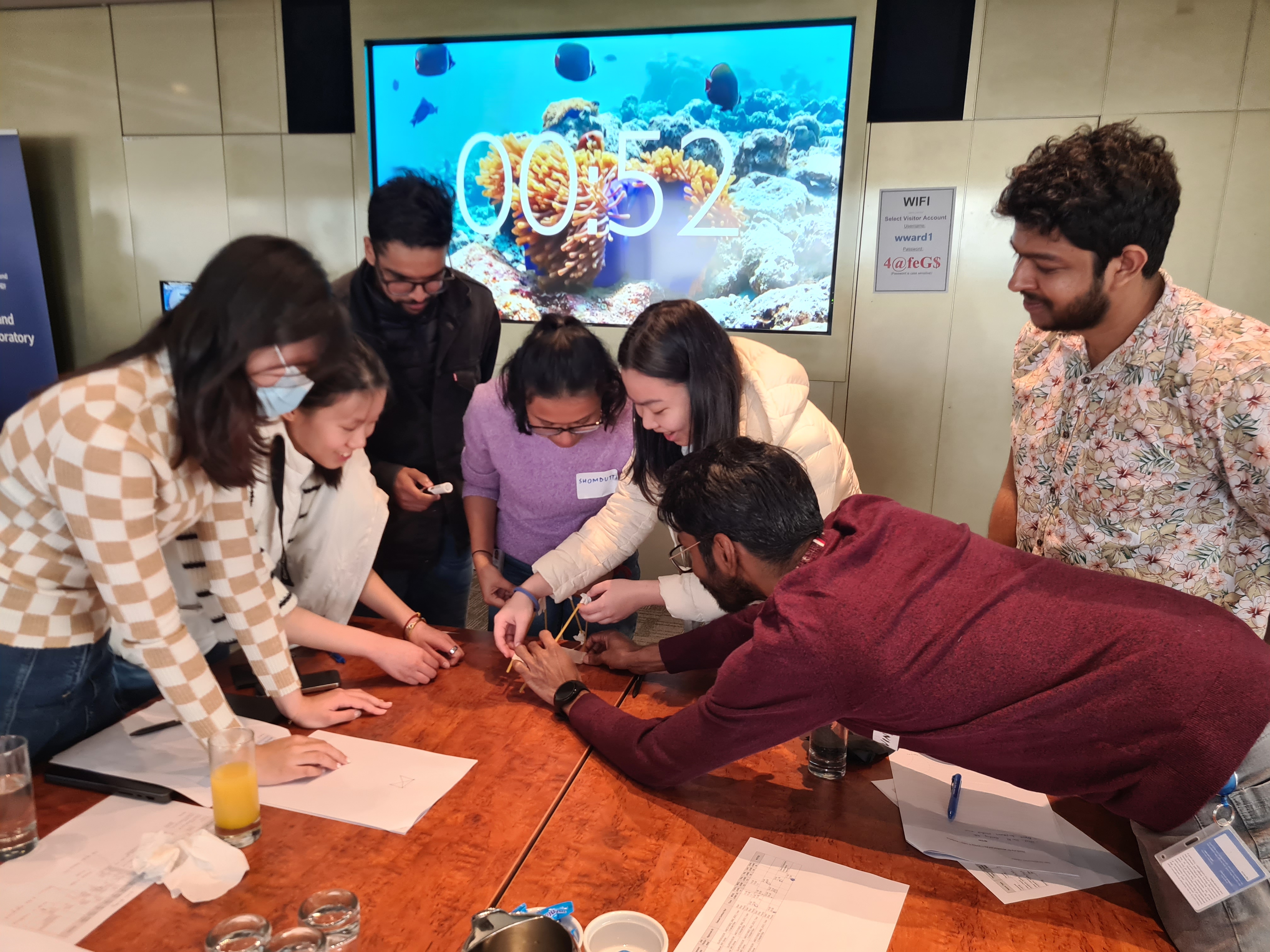 A group of 8 new tutors participate in a hands-on group activity