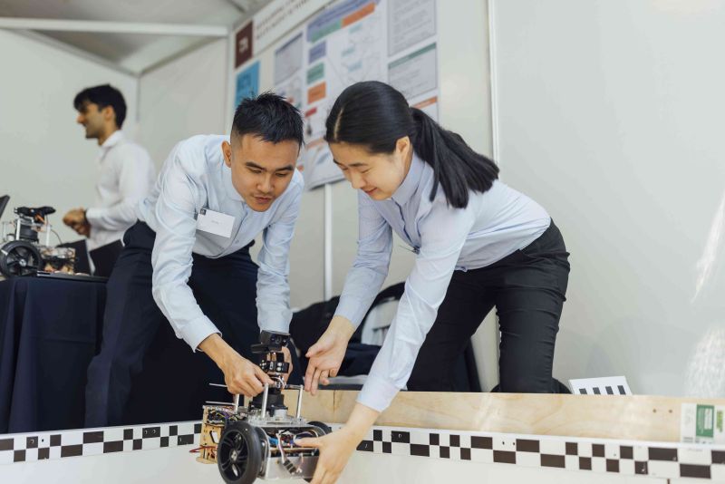 Two students with model robot.