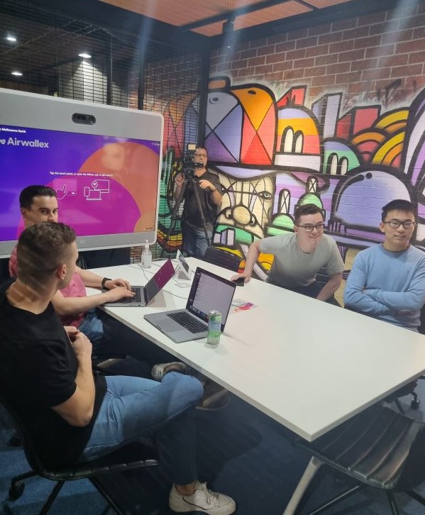 People sitting at a desk during the Airwallex 