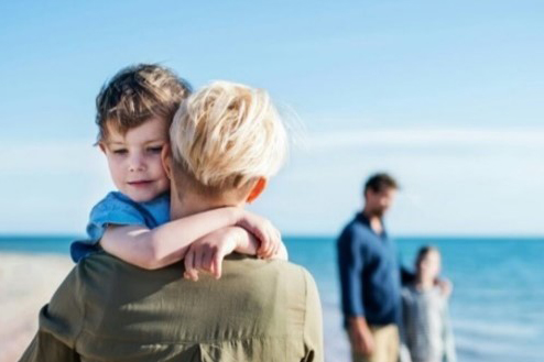 Image of mother holding son in her arms
