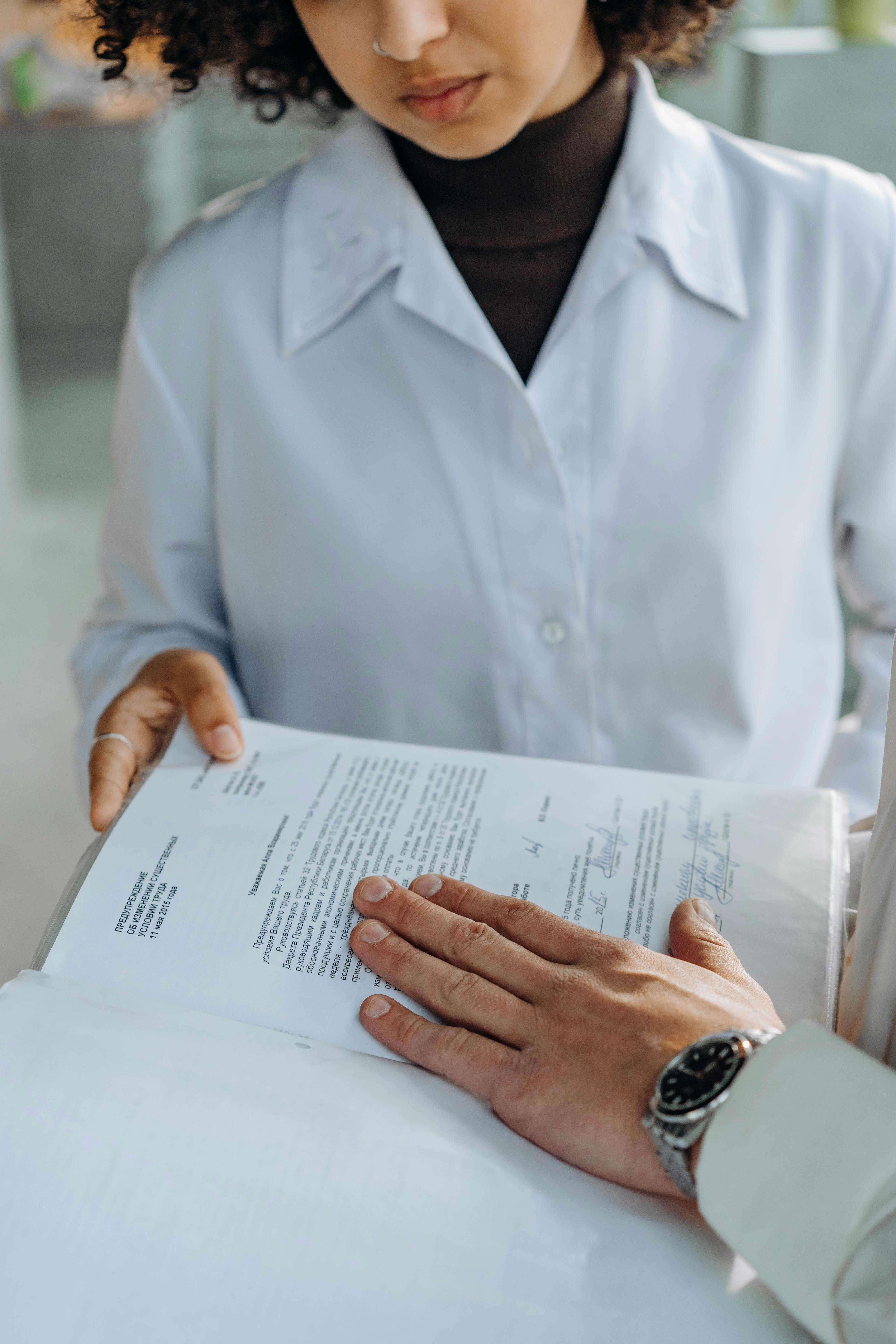 Person signing official piece of paper