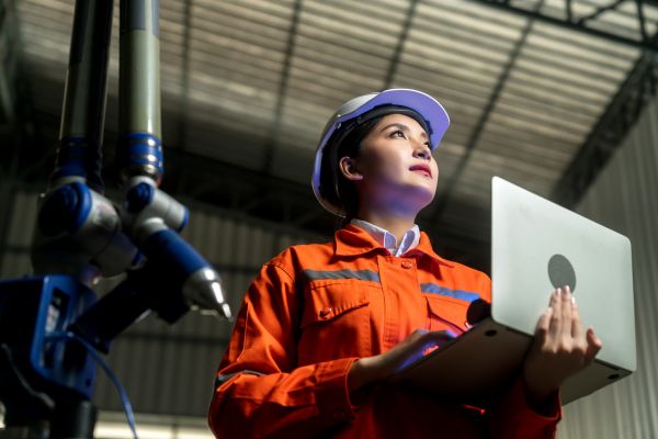 Lady in hard hat with laptop