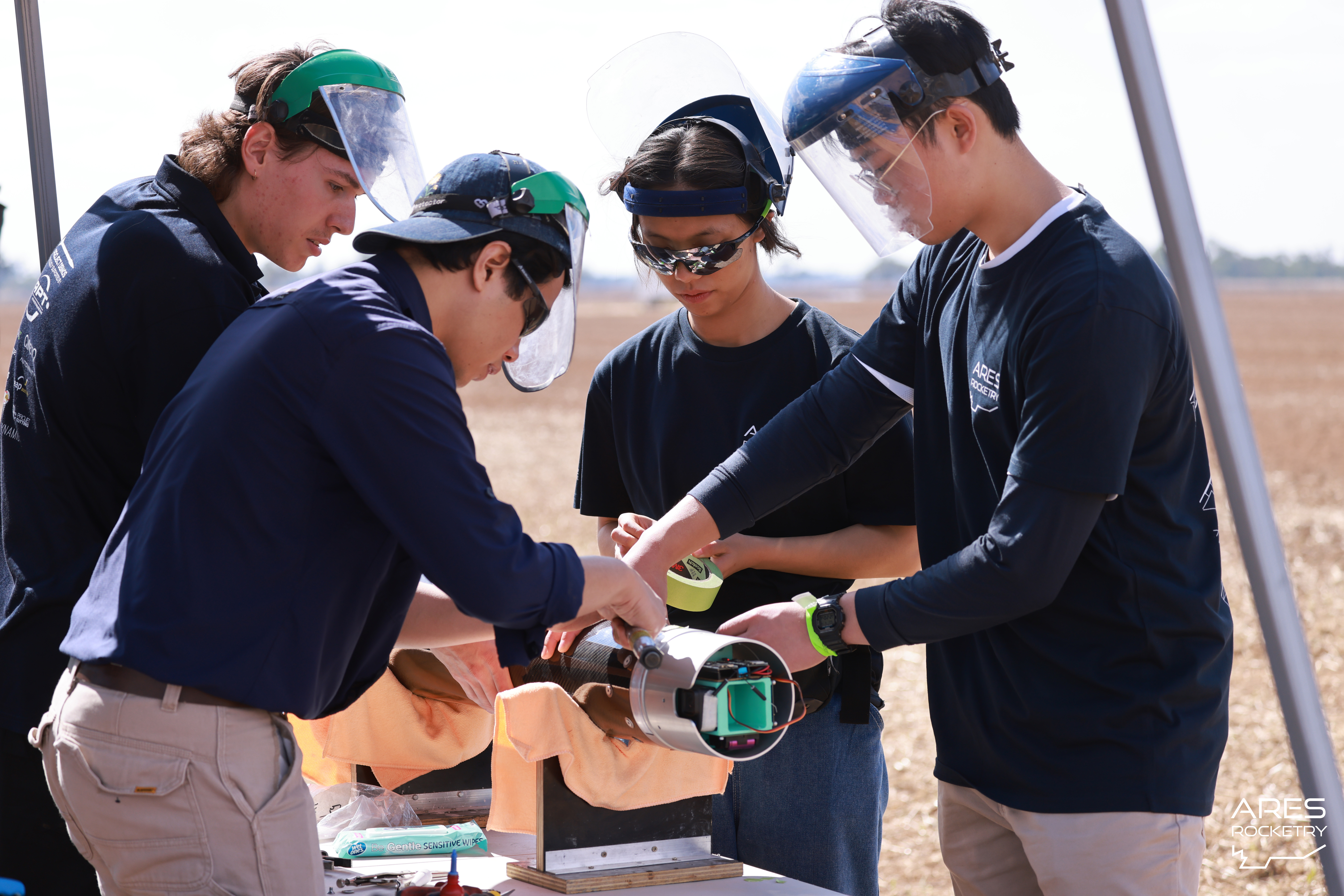 Team members integrating rocket