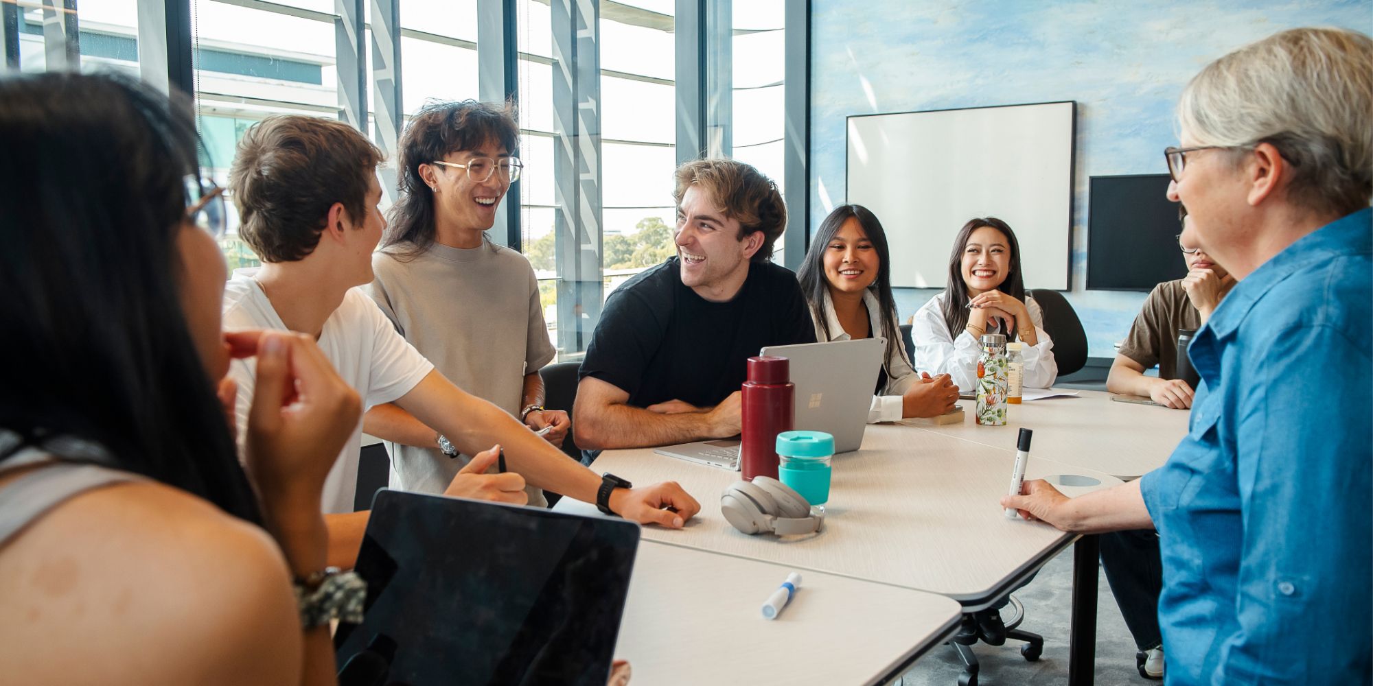 Smiling students around a table