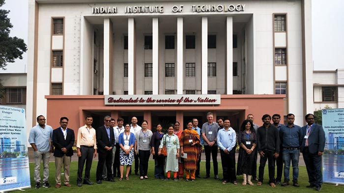 Meenakshi with colleagues standing on lawn in front of Indian Institute of Technology