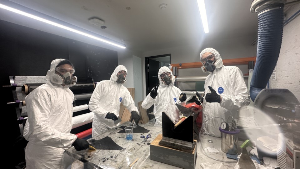 Team members manufacturing composites