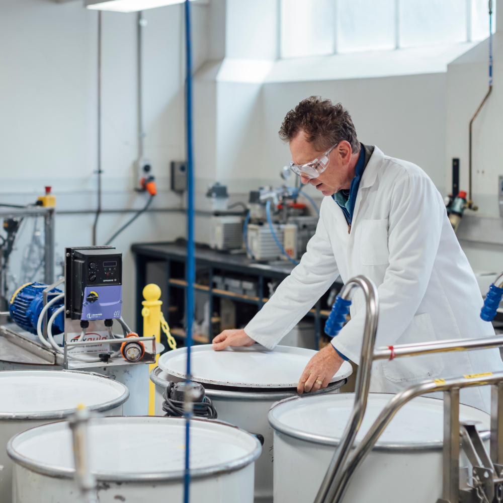 A person in PPE in a lab
