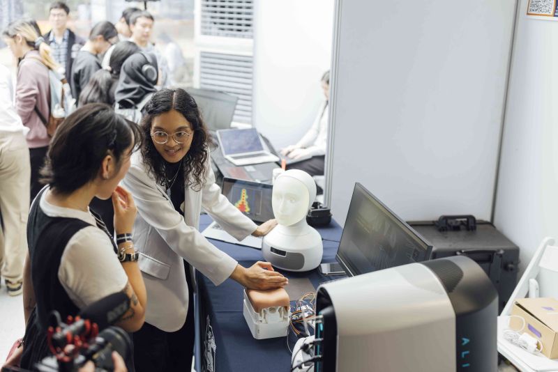Two students at Endeavour exhibition stand.