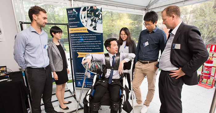 students presenting their work at an exhibition