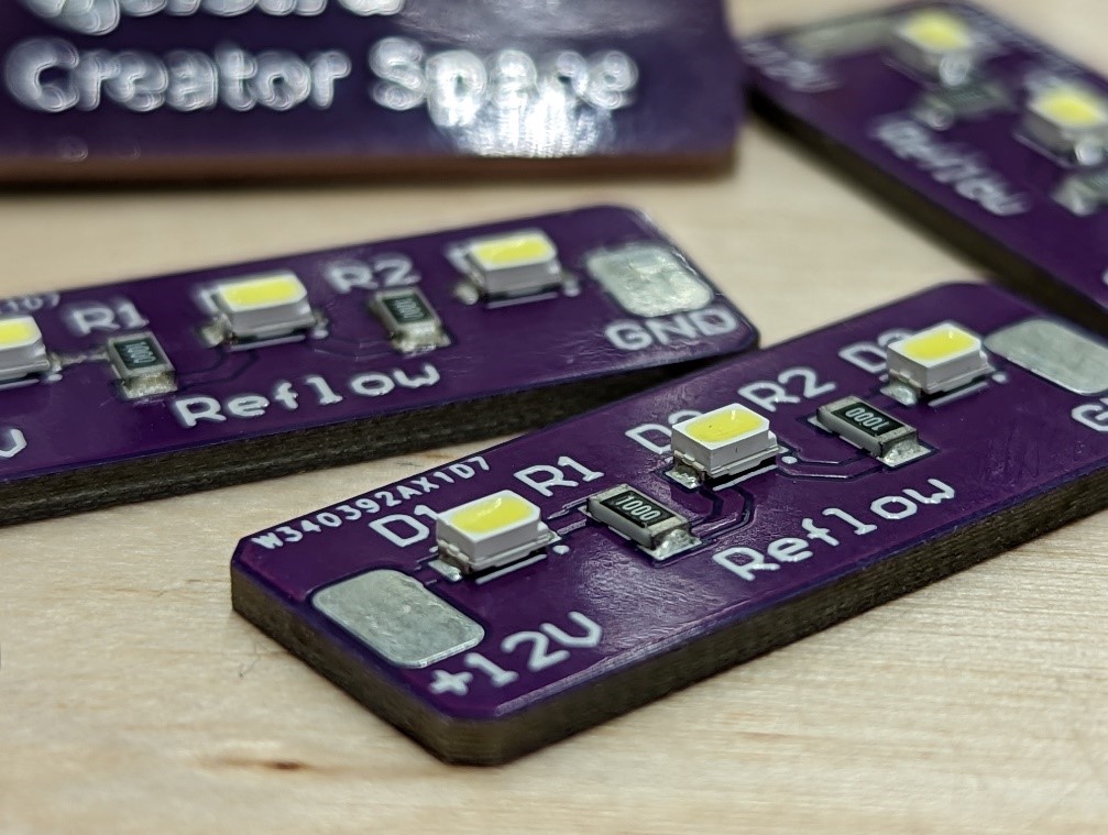 A close up macro image of printed circuit boards with 'Telstra Creator Space Reflow' printed on.