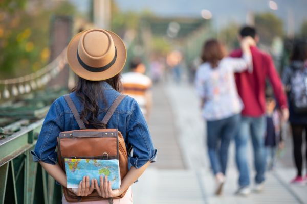 Female tourist with backpack on bridge 