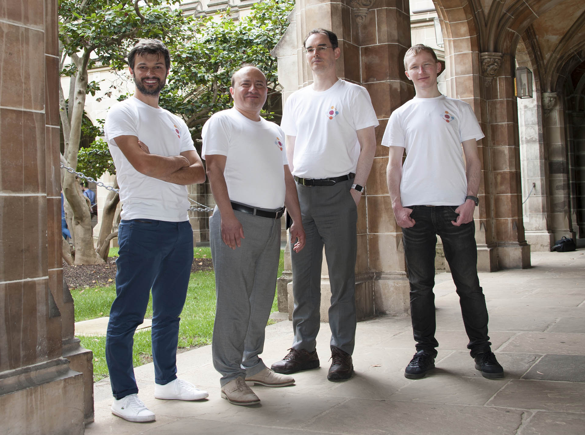 Four men wearing white Apromore branded t-shirts
