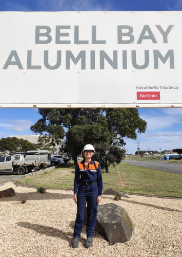 Kamya in front of the Bell Bay Aluminium sign