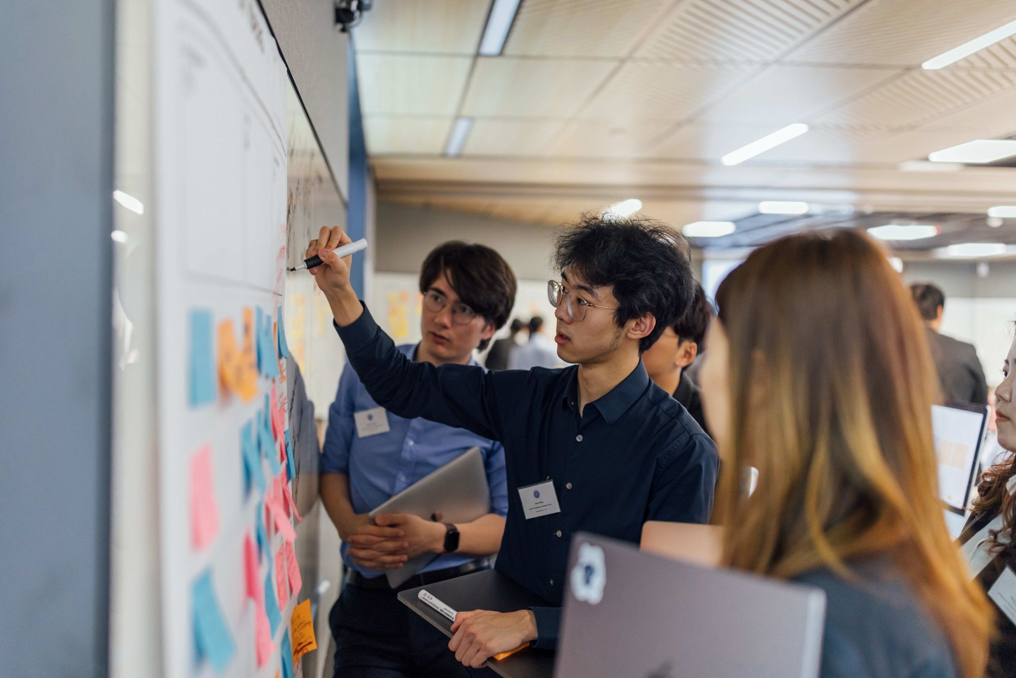 Students writing on a whiteboard