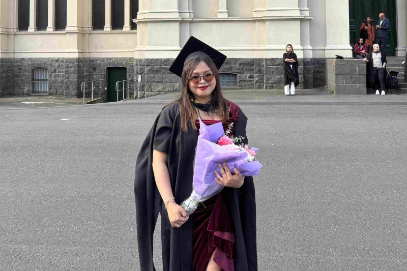 Girl in academic dress at graduation.