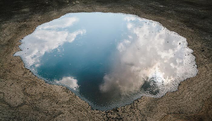 A puddle reflecting the sky