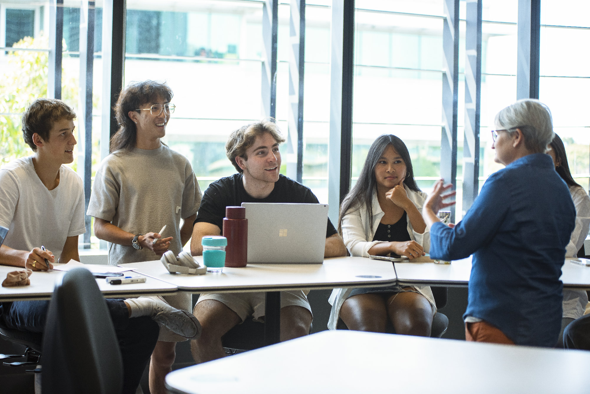 Students listening to a teacher in a lab