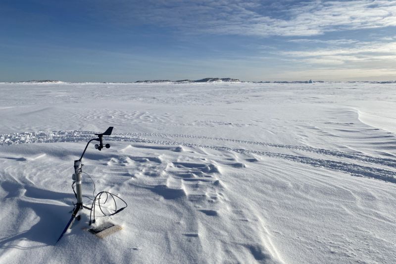Device on snowy Antarctic landscape.