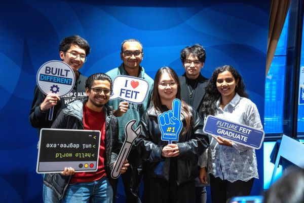 Mentor Group posing for photo with props